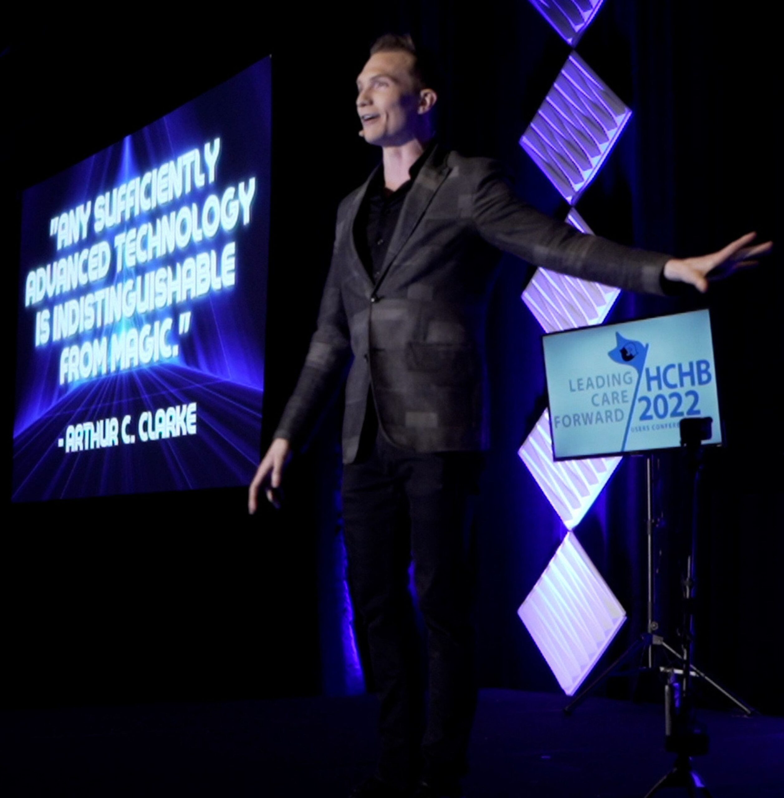 Trigg on stage performing for a large audience.