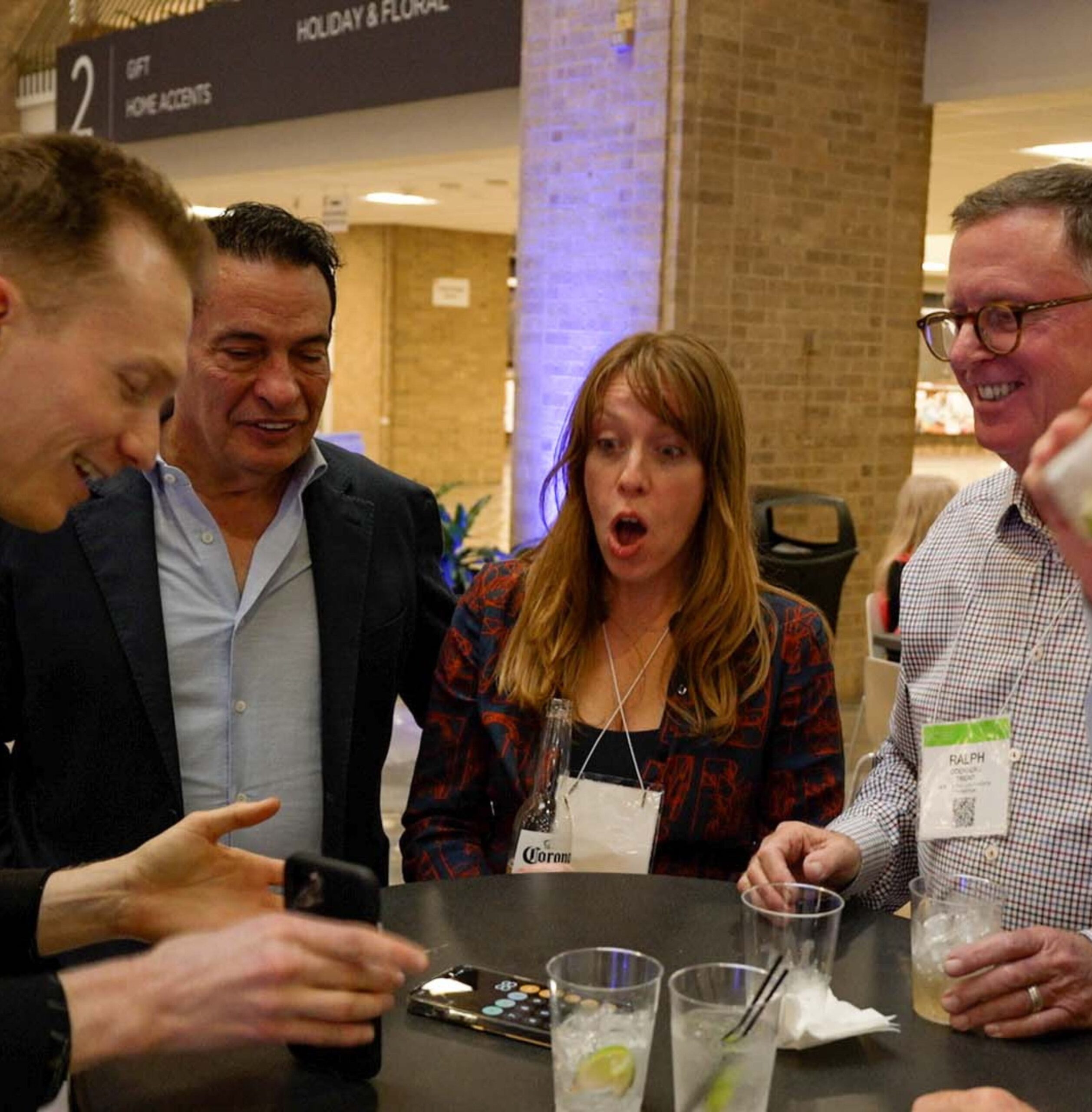 People react to Trigg's magic during a cocktail party.