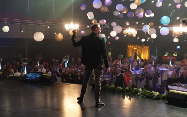 Trigg Watson on stage at a holiday event