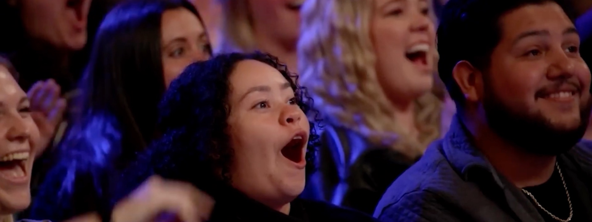 Audience members gasping and cheering during a Trigg Watson performance